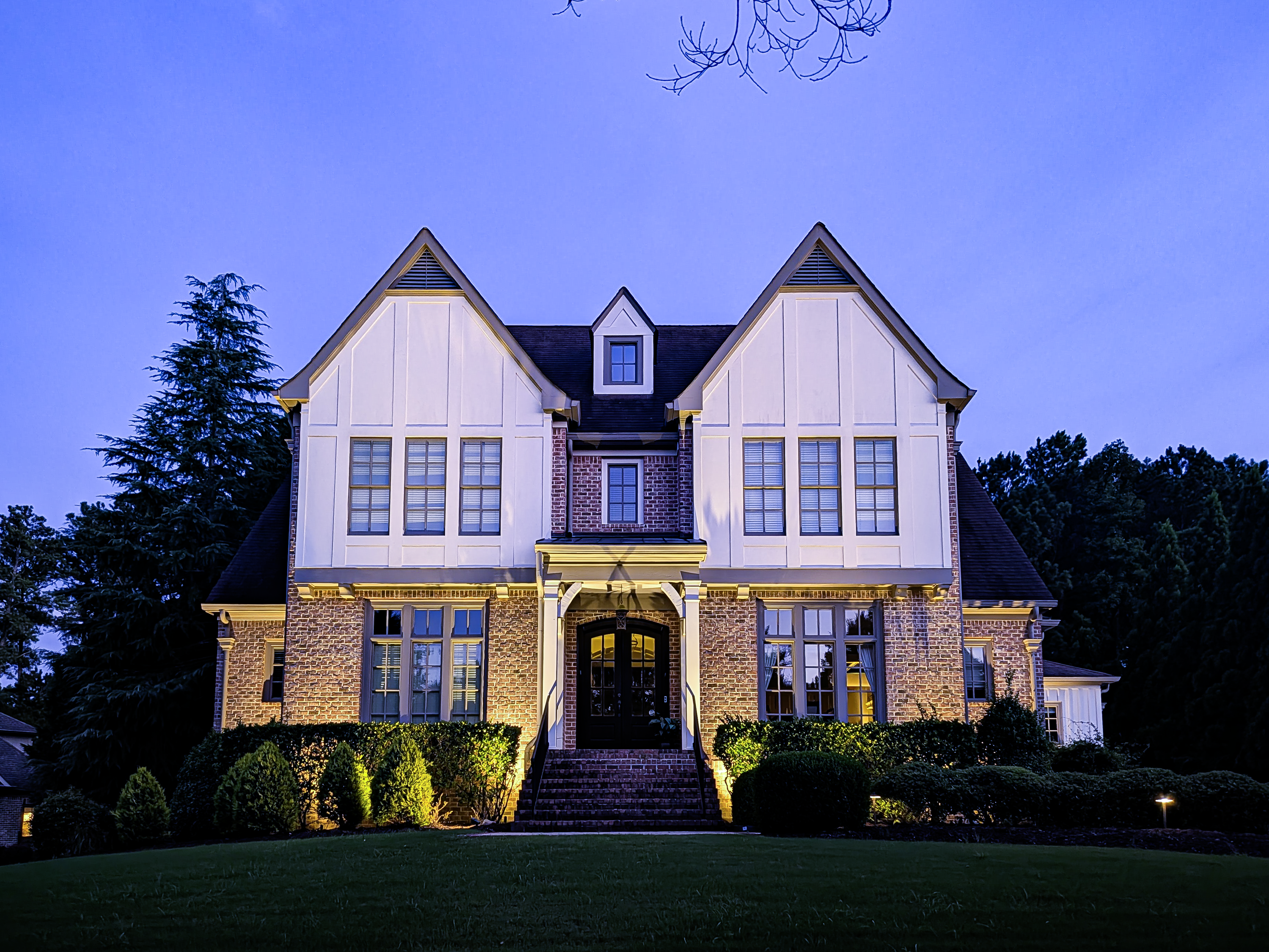 Newhaven home illuminated with layered landscape lighting at dusk